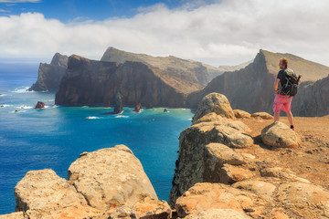 Tourist on the cliffs in the beautiful landscape of the east coast of the island Madeira at Ponta de Sao Lourenco nature reserve