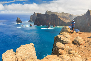 Tourist on the cliffs in the beautiful landscape of the east coast of the island Madeira at Ponta de Sao Lourenco nature reserve