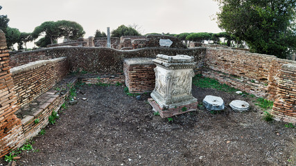 The room of the Shrine of the Altar of the Twins with the marble altar engraved with the discovery of Romulus and Remus and the chariot of Mars - Ostia Antica - Rome