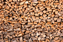 Stacked Firewood Close Up. Nicely Stacked Pile Of Firewood Close Up. Natural Wall Of Chopped Dry Firewood. Preparation Of Firewood For Winter.