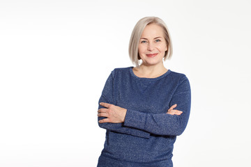 Wall Mural - attractive middle aged woman with folded arms on white background