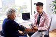 © Monkey Business - Male Doctor In Office Checking Senior Female Patients Blood Pressure
