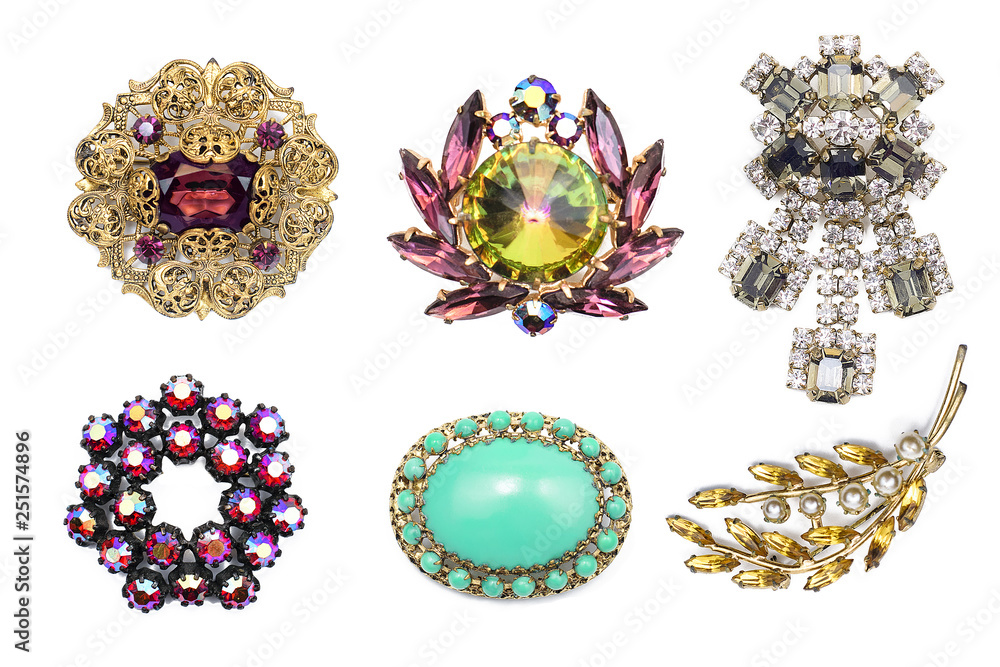 A lot of vintage precious brooch on a white isolated background - obrazy, fototapety, plakaty 