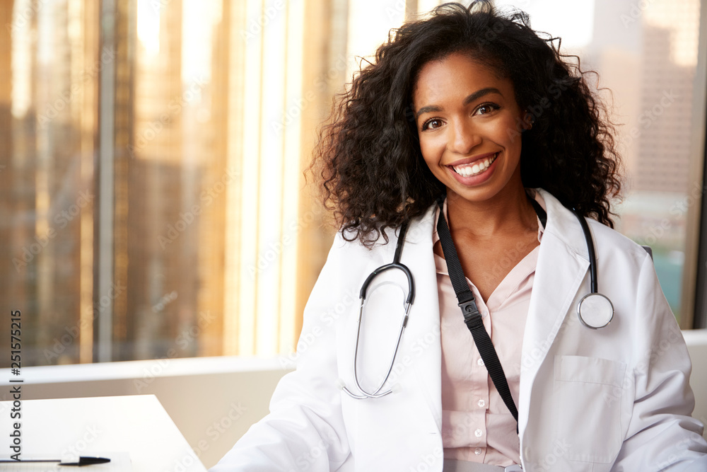 Portrait Of Smiling Female Doctor Wearing White Coat With Stethoscope In  Hospital Office Stock Photo | Adobe Stock