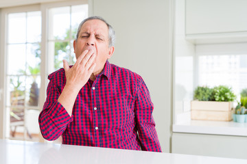 Sticker - Handsome senior man at home bored yawning tired covering mouth with hand. Restless and sleepiness.