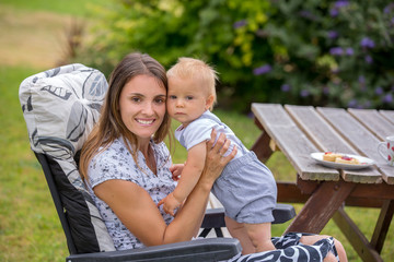 Sticker - Young mother, holding her baby boy, breastfeeding him in the afternoon