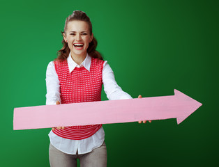 Wall Mural - happy fit learner woman giving big pink arrow pointing right