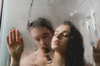 © LIGHTFIELD STUDIOS - selective focus of hot naked man and attractive woman hugging in shower cabin