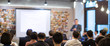 Speaker Presenting Presentation to Audience. Defocused Blurred Conference Executive Presenter Giving Speech to Audience. Business Meeting for Professionals. Technology Lecturer Educating Entrepreneurs