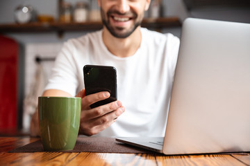 happy young man using laptop computer