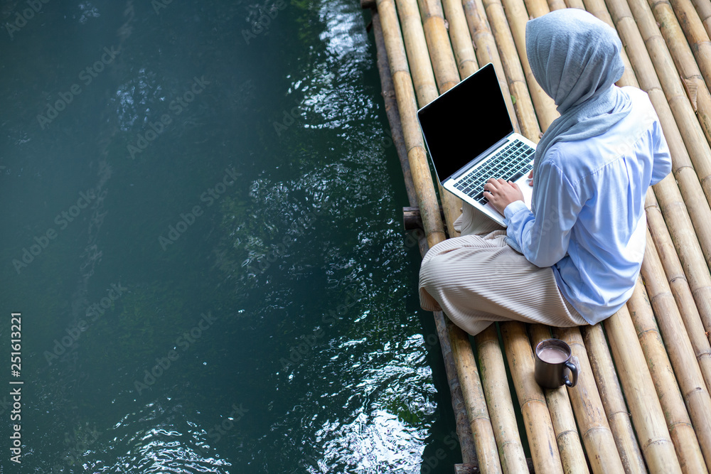 business owner young Muslim woman wearing hijab working with laptop on ...