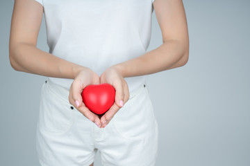 Close up of a red heart on a woman hand. It shows a love that is full of happiness. Combination of love of two people. To bring love together is a good thing to the whole world. Health care concept