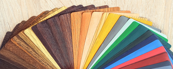 Lamination samples. On a wooden background for lamination of any wooden and plastic products used in construction.