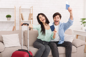 Wall Mural - Happy couple holding passports and tickets in hands