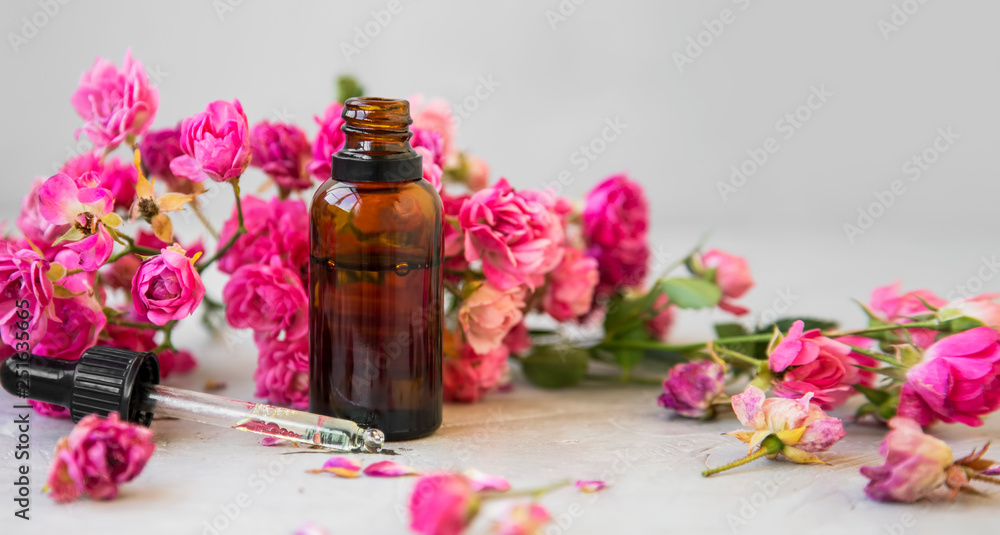 Rose oil. Spa and aromatherapy rose flowers essential oil bottle with pipette - obrazy, fototapety, plakaty 