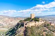 The view from another tower of Lorca Castle in southern Spain, shows the great tower and surrounding walls of the keep, with a trebuchet replica standing ready to attack. 