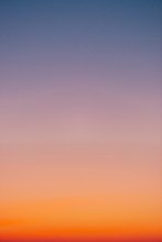 Predawn Clear Sky With Orange Horizon And Violet Atmosphere. Smooth Orange Violet Gradient Of Dawn Sky. Background Of Day Beginning. Heaven At Early Morning With Copy Space. Sunset, Sunrise Backdrop