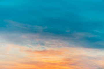 Wall Mural - sunset sky with orange yellow light clouds. colorful smooth blue sky gradient. natural background of
