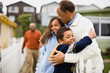 © Erickson Stock - Grandfather hugging his Granddaughter and Grandson with their Father in the background
