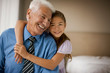 © Erickson Stock - Smiling grandfather with his daughter