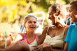 © Erickson Stock - Mature woman relaxing and having fun with her grandchildren during their vacation.