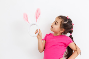 Wall Mural - Happy lost tooth little girl wearing funny bunny ears