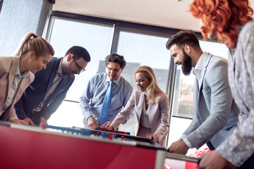 Poster - Coworkers playing table football on break from work