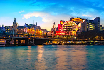 Wall Mural - Night view of the Embankment tube station and blackfriars bridge reflected in the Thames river in London, UK