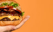 © Dmitry Lobanov - Close up big cheeseburger barbeque sandwich with marble beef on yellow