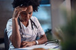 © Drazen - Worried black female doctor reading medical documents at the office.