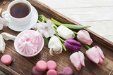Fototapeta Tulipany - Tulips and cup of coffee with dessert on white background. Conce
