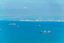 Cargo Ships At Mediterranean Sea With City Of Akko At Background, Israel