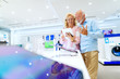 © Dusan Petkovic - Excited senior couple trying out tablet while standing in tech store. Woman holding tablet.