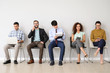 © Pixel-Shot - Young people waiting for job interview indoors