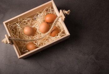 Easter basket with eggs, shot on a dark background