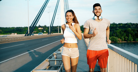 Attractive man and beautiful woman jogging together