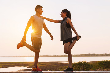 Wall Mural - young couple doing exercises and warm up before run and Physical fitness test