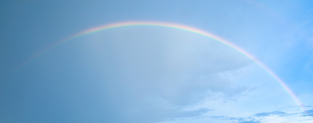 real rainbow on blue sky after raining.