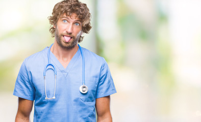 Poster - Handsome hispanic surgeon doctor man over isolated background sticking tongue out happy with funny expression. Emotion concept.