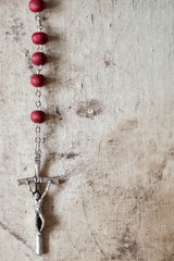 Wall Mural - Catholic rosary hanging on old canvas