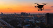 © Naypong Studio - Silhouette of drone flying above city at sunset