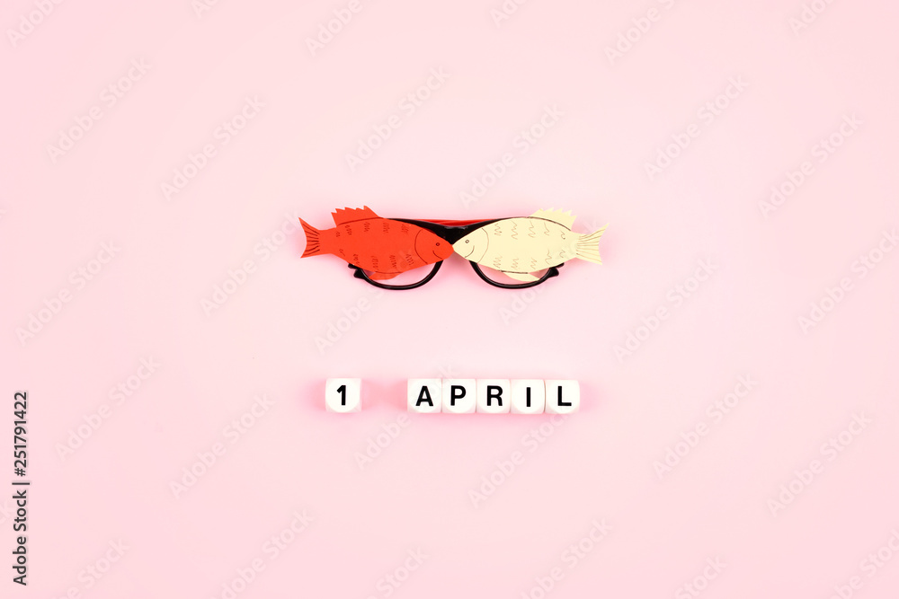 April Fools' Day celebration. Glasses with paper fish and text 1 April ...
