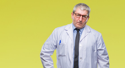 Wall Mural - Handsome senior doctor, scientist professional man wearing white coat over isolated background skeptic and nervous, frowning upset because of problem. Negative person.