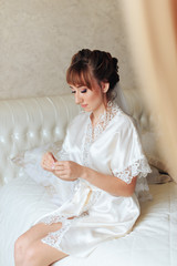 morning of the bride, a beautiful woman in a white dress is preparing for the wedding 1