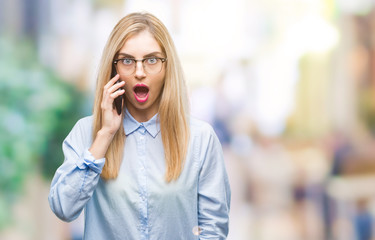 Canvas Print - Young beautiful blonde business woman calling on smartphone over isolated background scared in shock with a surprise face, afraid and excited with fear expression