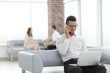 © yurolaitsalbert - businessman working sitting in the lobby of a modern office