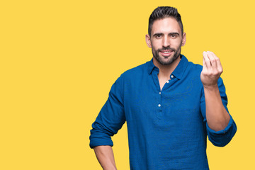 Young handsome man over isolated background Doing Italian gesture with hand and fingers confident expression