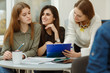 © Nestor - Students doing common project for their studies together. Girls learning foreign language together on courses in private school. Colleagues working under interesting presentation and drinking tea.