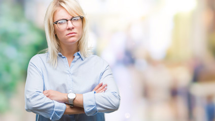 Poster - Young beautiful blonde business woman wearing glasses over isolated background skeptic and nervous, disapproving expression on face with crossed arms. Negative person.