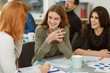 © Nestor - Happy beautiful pupils smiling and talking with each other. Young people feeling themselves comfortable during language courses. Girls drinking tea and working under common interesting presentation.